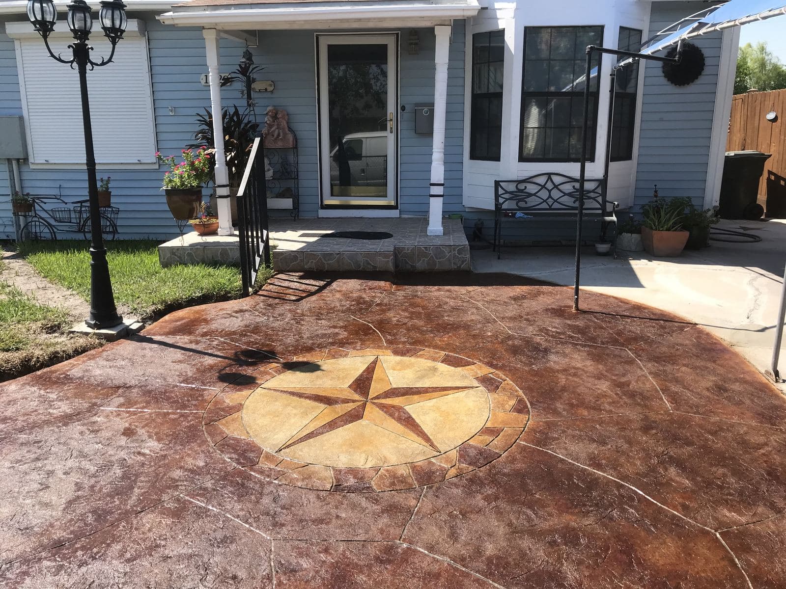 Acid-stained front courtyard with a gold Texas star in the center