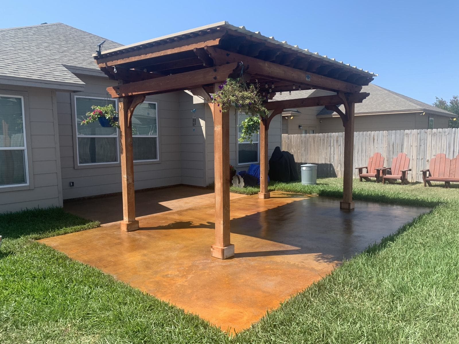 Acid-stained patio beneath a cedar pergola