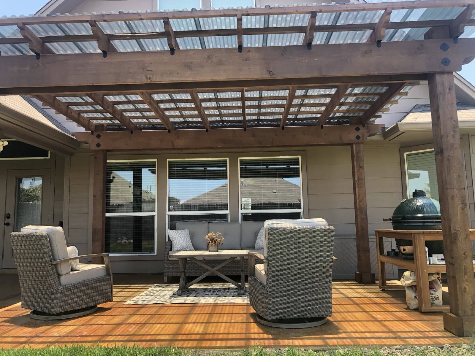 Cedar pergola over a finished patio with outdoor furniture and a grill