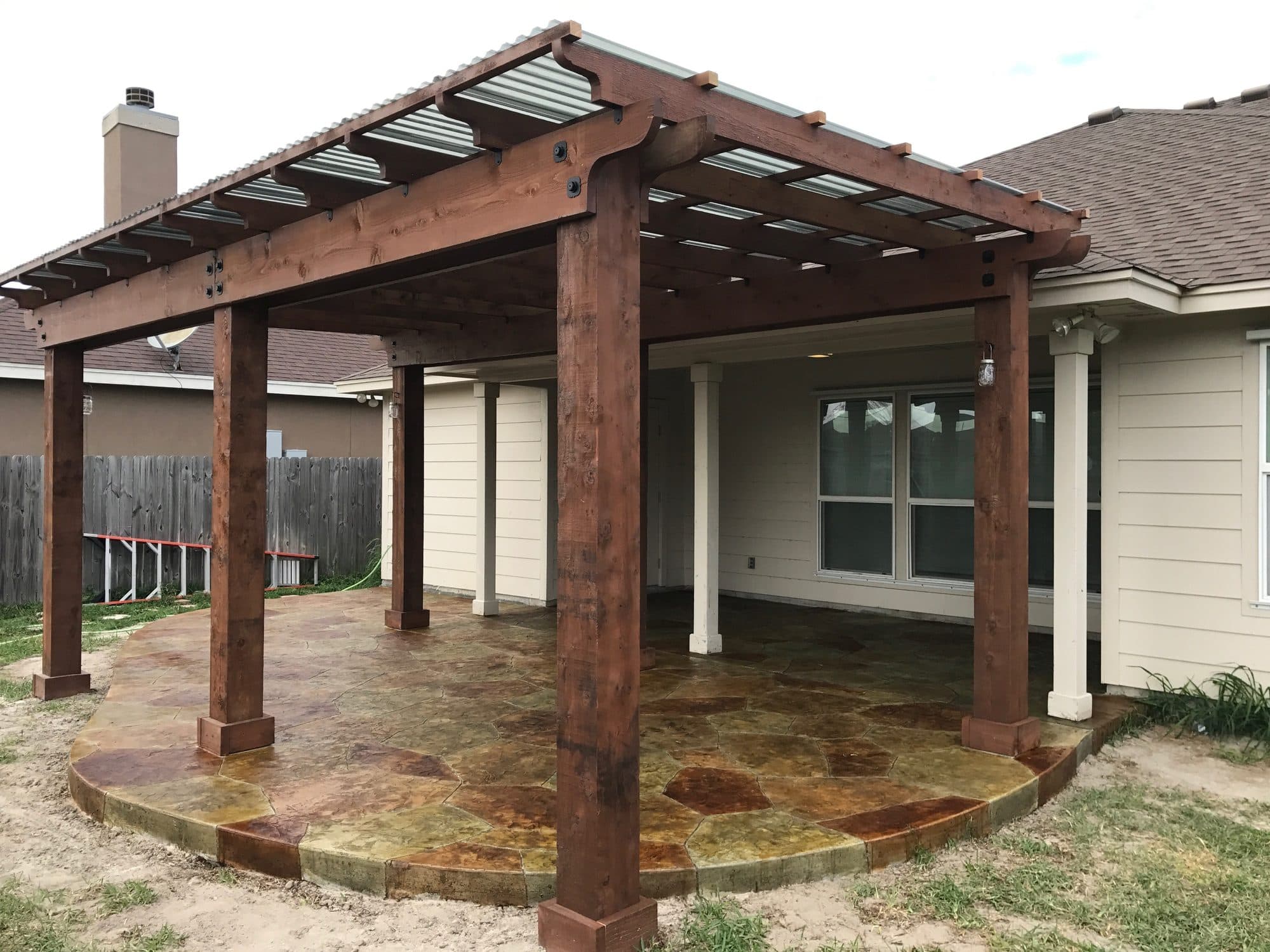 Gabled cedar pergola over a stained concrete patio