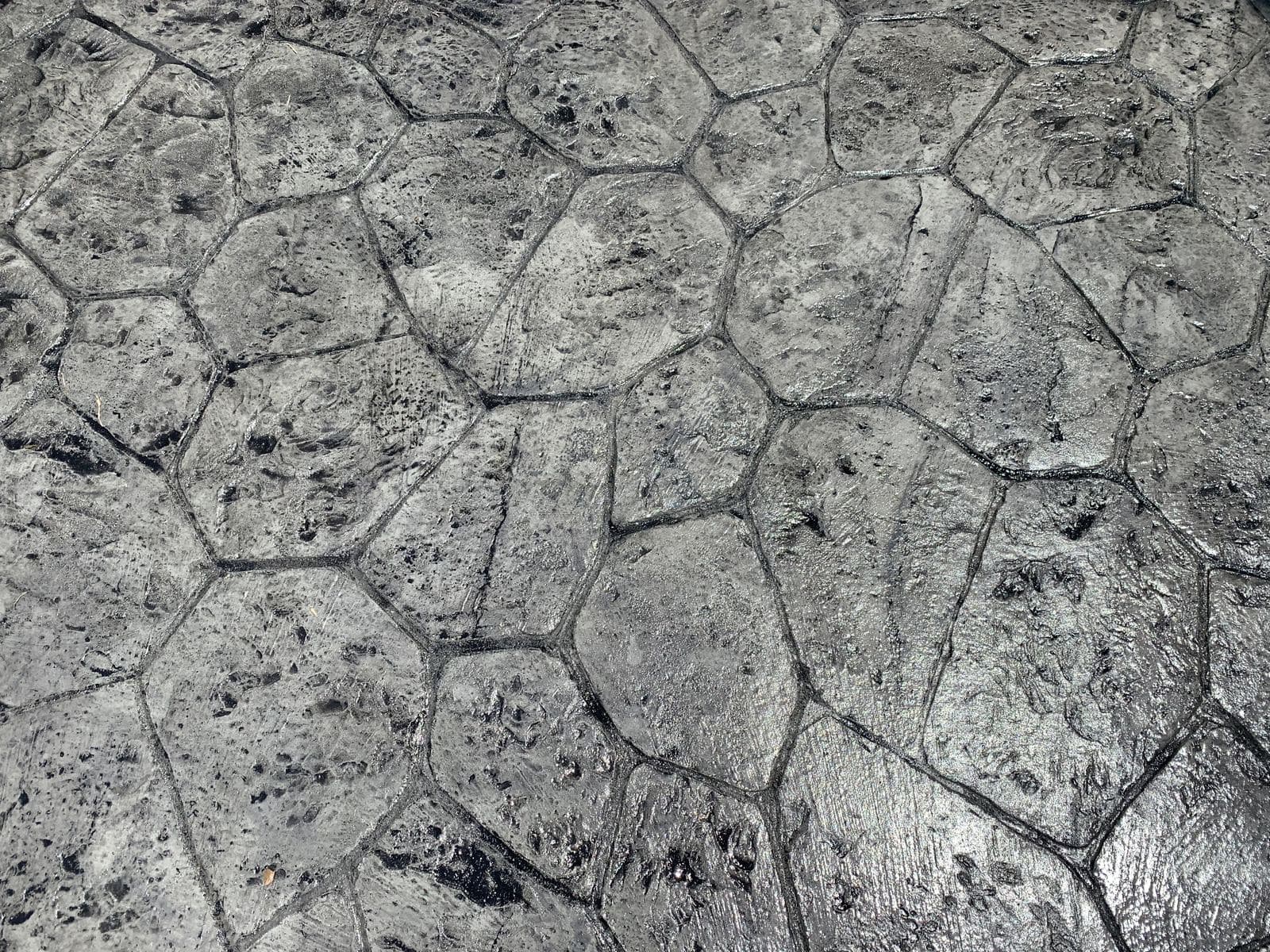 Close-up of gray flagstone-pattern stamped concrete