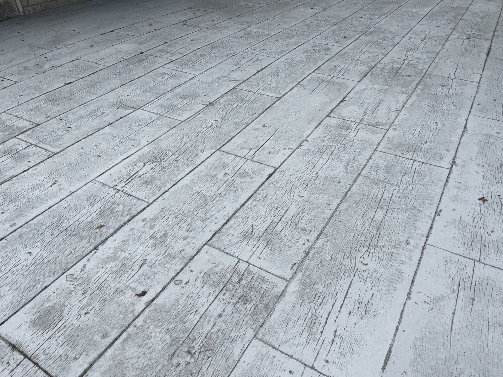 Stamped concrete finished to look like weathered wood planks